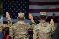 Military veterans are sworn in during a naturalization ceremony at a Veteran's Day event at Fort Sam Houston National Cemetery, Thursday, Nov. 11, 2021, in San Antonio. (AP Photo/Eric Gay)