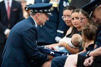 Airmen from the U.S. Air Force Honor Guard and a bugler from the U.S. Air Force Band’s Ceremonial Brass conduct military funeral honors for U.S. Air Force Capt. Wade Holmes in Section 57, Arlington National Cemetery, Arlington, Virginia.