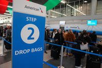 Holiday travelers gather at O'Hare International Airport during Thanksgiving week Wednesday, Nov. 26, 2025, in Chicago. (AP Photo/Erin Hooley)