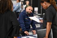A job fair attendee acknowledges the camera.