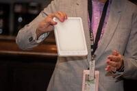 A psychologist displays a light therapy box.