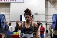 A Marine performs a barbell squat.