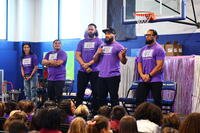 WWE stars stand on stage addressing students during a Purple Up Day event at Coral Academy of Science. Photo Credit: Michael Kirschbaum.