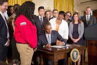 President Barack Obama signing a memorandum.