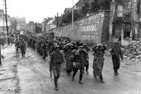 German prisoners march out of surrendered Cherbourg under U.S. Army guard.