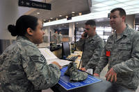 Staff Sgt. Jessicca Montague speaks with Staff Sgt. Nathan Ronimous, 731st Air Mobility Squadron passenger service supervisor, about Space-Available travel at the Osan passenger terminal, April 23, 2013. (Photo: U.S. Air Force)