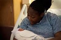 An Air Force spouse holds her newborn at Nellis Air Force Base, Nevada. (U.S. Air Force/Airman 1st Class Timothy Young)