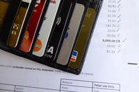 wallet full of credits cards on top of statement