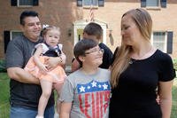 Family in front of house