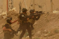 Security forces defend their headquarters against attacks by Islamic State extremists during sand storm in the eastern part of Ramadi, Iraq, Thursday, May 14, 2015.. (AP Photo)
