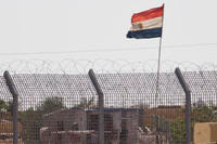 An Egyptian military officer watches at a post in Egypt's northern Sinai Peninsula, as seen from the Israel-Egypt border, in Kerem Shalom village, southern Israel, Wednesday, July 1, 2015. (AP Photo/Ariel Schalit)