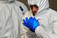 Army Lt. Col. Kevin Baird practices donning protective gear on Fort Eustis, Va. as soldiers heading to West Africa are trained on Ebola outbreak precautionary measures. (DoD photo)