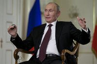 Russian President Vladimir Putin gestures while speaking to John Daniszewski, the Associated Press's Senior Managing Editor for International News, during an AP interview at Putin's Novo-Ogaryovo residence outside Moscow, Russia,
