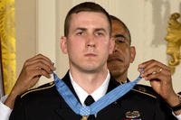 President Barack Obama bestows former Army Staff Sergeant Ryan M. Pitts with the Medal of Honor in the East Room of the White House Monday, July 21, 2014, in Washington. (AP Photo/Jacquelyn Martin)