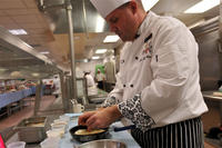 Army Sgt. Andrew Shurden prepares a potato dish during tryouts for the culinary arts team at Joint Base Lewis-McChord, Wash., Nov. 21, 2014. (Army photo by Sgt. James J. Bunn)