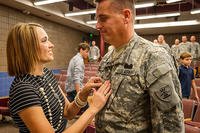 North Dakota National Guard’s Jon Erickson has his new rank of colonel affixed to his uniform by his wife Janelle at his promotion ceremony. (U.S. Army National Guard/Staff Sgt. Brett Miller)