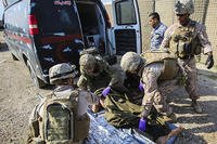 U.S. Navy corpsmen and a member of the U.S. Army 772nd Forward Surgical Team prepare an Iraqi soldier that sustained combat-related injuries for transport. (U.S. Marine Corps/Sgt. Ricardo Hurtado)