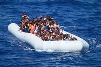 Migrants aboard an inflatable vessel approach the guided-missile destroyer USS Carney in the Mediterranean Sea on July 29, 2016. Chief Information Systems Technician Wesley R. Dickey/Navy