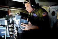 A crewman changes out film on board an OC-135B Open Skies observation aircraft. Another Open Skies plane made an emergency landing in Russia on July 27. (US Air Force/Perry Aston)
