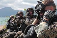 Marines prepare their diving equipment prior to entering the water on Jan. 22, 2014, at Marine Corps Air Station Kaneohe Bay, Hawaii. (U.S. Marine Corps photo/Brandon Suhr)
