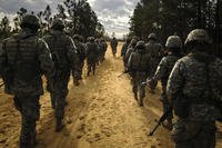 Recruits march along dirt road.