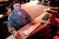 Service member using computer.