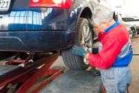 auto mechanic with car lift (Public domain photo)