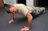Master sergeant participates in push-up contest.