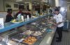 A Marine chief cook goes over the chow line.