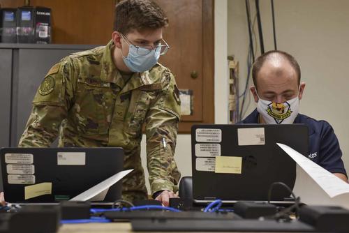 Two airmen explore ways to remotely add computers at Seymour Johnson Air Force Base.