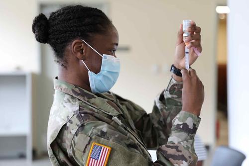 National Guardsman prepares to administer the Moderna COVID-19 vaccine.