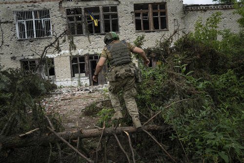 A Ukrainian serviceman runs to his position.