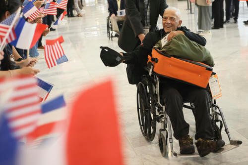 D-Day veteran Anthony Pagano arrives at Charles de Gaulle airport.