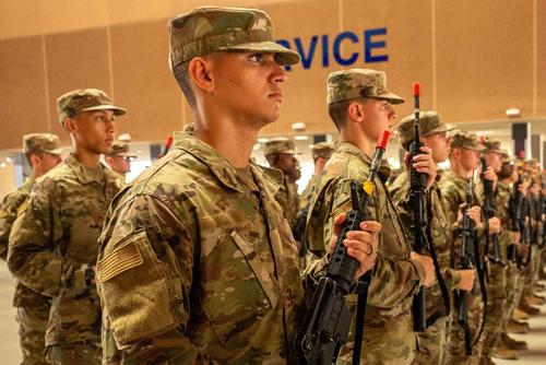 U.S. Air Force Basic Military Training trainees carry weapons