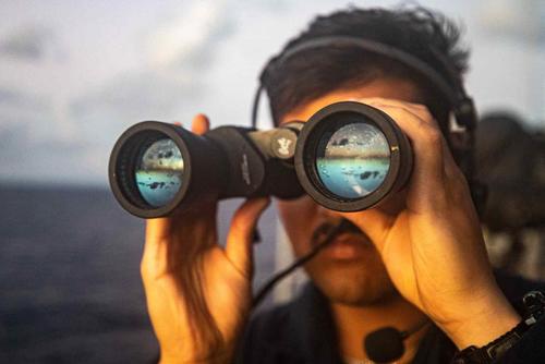 Navy sailor scans for surface contacts aboard the USS Chancellorsville