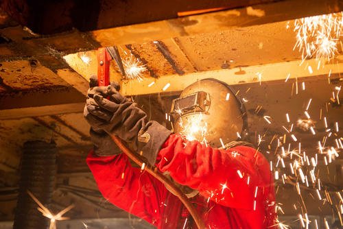 A Newport News Shipbuilding contractor uses a carbon arc