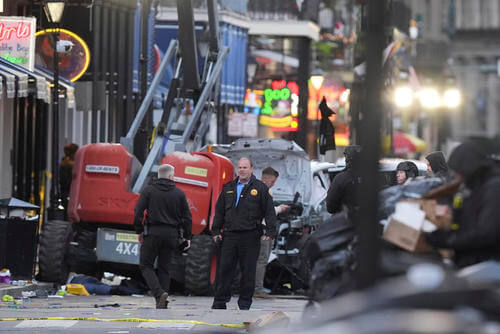 Security personnel investigate the scene on Bourbon Street after a vehicle drove into a crowd on New Orleans' Canal and Bourbon Street