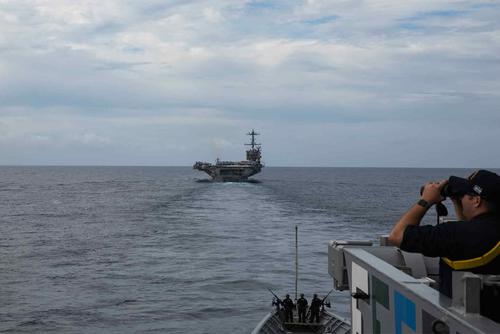 Sailors assigned to the USS Gettysburg observe the USS Harry S. Truma