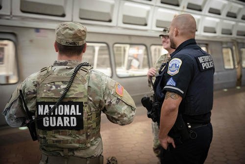 U.S. soldiers with the West Virginia National Guard conduct a routine patrol at the Stadium-Armory Metro Station in Washington, D.C.