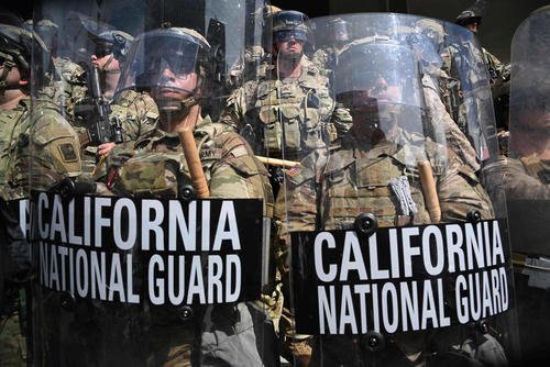 California National Guard stand guard as protesters gather during the No Kings protests in Los Angeles.