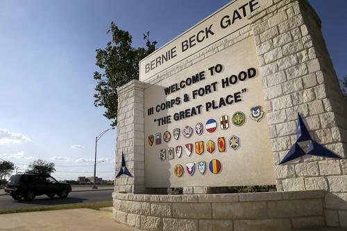Traffic flows through the main gate past a welcome sign, Tuesday, July 9, 2013, in Fort Hood, Texas. (AP Photo/Tony Gutierrez)