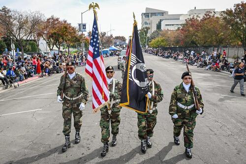 Veterans carry U.S. in a parade in California.