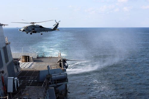 An MH-60R Sea Hawk, assigned to Helicopter Maritime Strike Squadron (HSM) 79, departs from the flight deck of the Arleigh Burke-class guided-missile destroyer USS Roosevelt (DDG 80) during a Strait of Hormuz transit. (U.S. Navy photo by Mass Communication Specialist 1st Class Indra Beaufort)